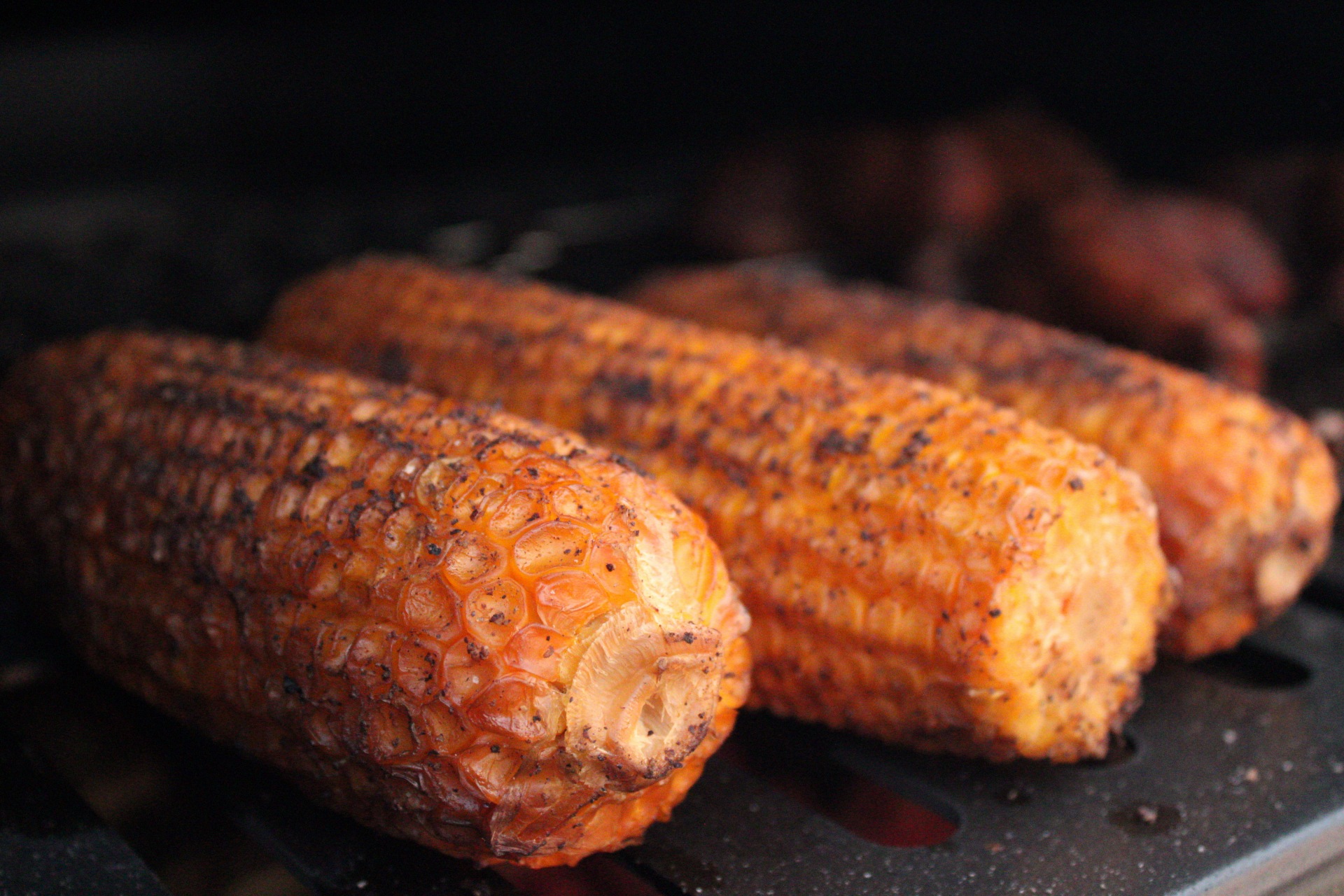 Whole smoked corn cobs on the grill